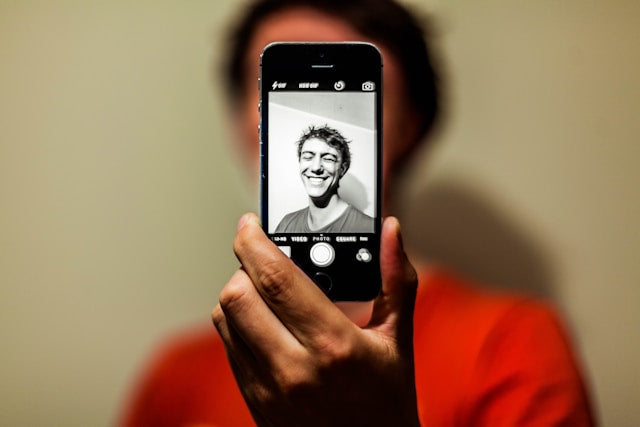 A person taking a selfie as part of their journey towards mindful photography